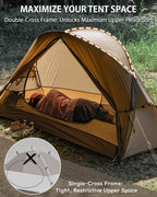 Lightweight camping tent with double-cross frame, person lying inside for maximum headroom, outdoor setting