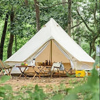 Large canvas bell tent set up in forest, surrounded by camping chairs and picnic table